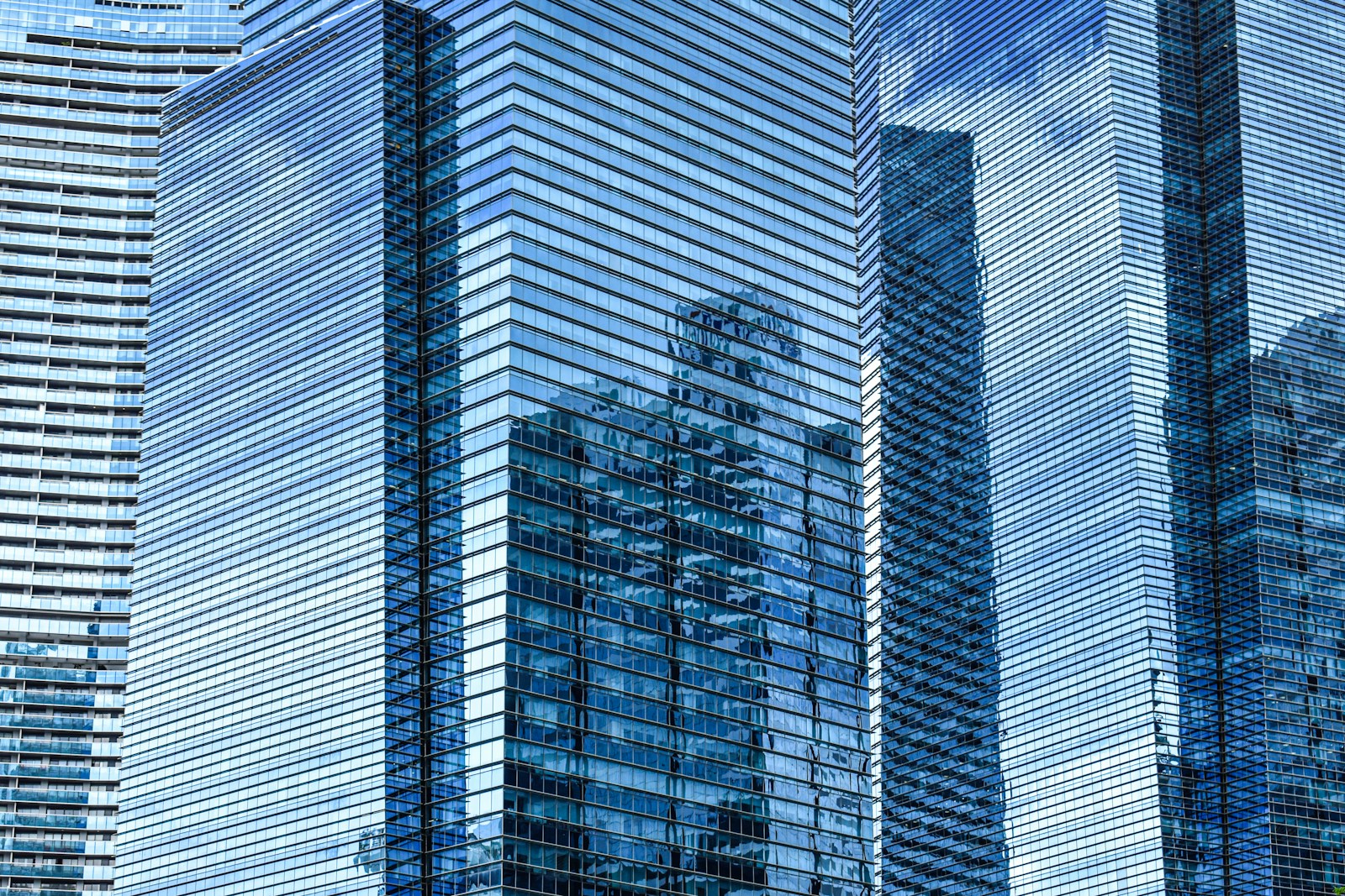 Modern glass skyscrapers reflecting the sky