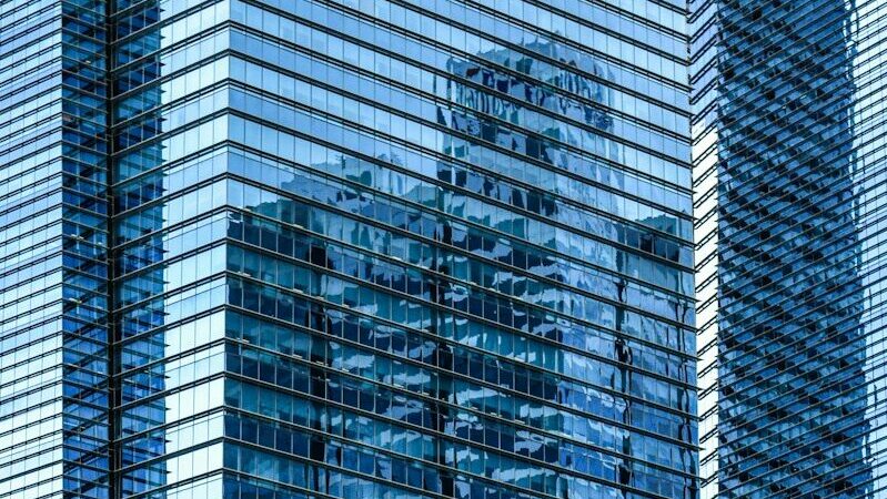 Modern glass skyscrapers reflecting the sky